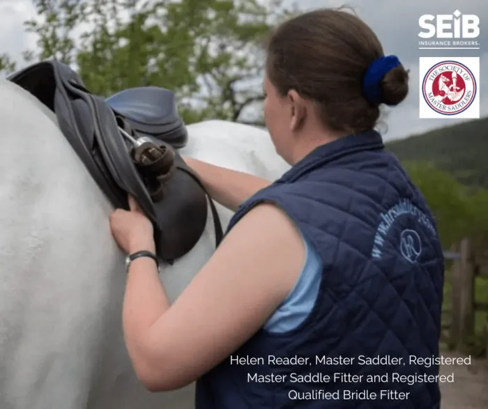 Helen Reader fitting a horse saddle